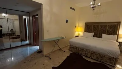 a bedroom with a bed and a table with a lamp at Marina View Luxury Retreat Modern Apartment JBR Dubai in Dubai
