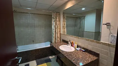 a bathroom with a sink and a mirror and a tub at Marina View Luxury Retreat Modern Apartment JBR Dubai in Dubai
