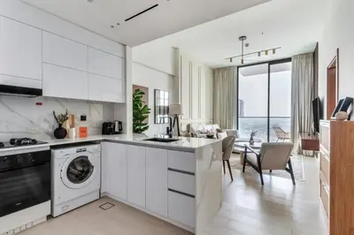 a kitchen with white cabinets and a dishwasher at GuestReady - Stunning unit at Binghatti House in Dubai