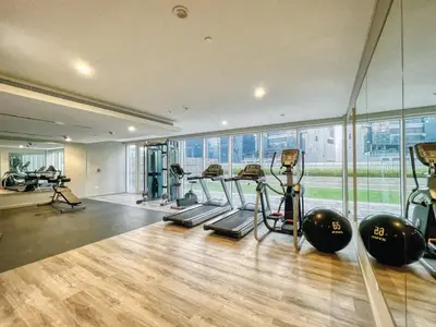 a gym with several treadmills and exercise bikes in it at GuestReady - Sleek city retreat in Business Bay in Dubai