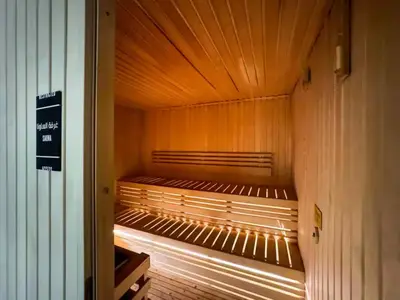 a sauna with wooden walls and a wooden ceiling at Highest Infinity Pool - Burj Khalifa View - Gym in Dubai