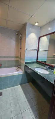 a bathroom with a sink and a tub and a mirror at Westin Marina in Dubai