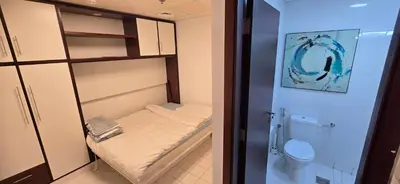 a small room with a bed and a toilet at Westin Marina in Dubai