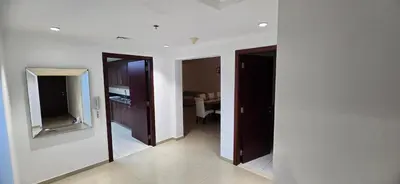 a hallway with two doors and a mirror in a room at Westin Marina in Dubai