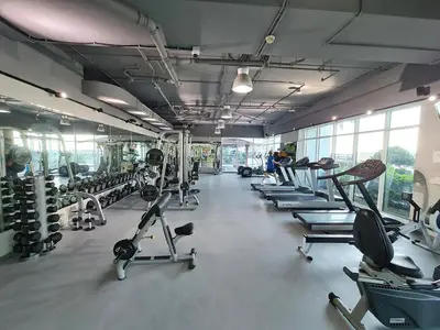 a gym with several rows of treadms and machines at Westin Marina in Dubai