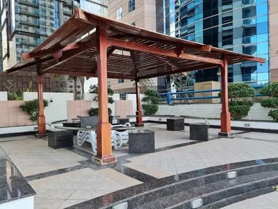 a pavilion with benches and tables in a city at Westin Marina in Dubai