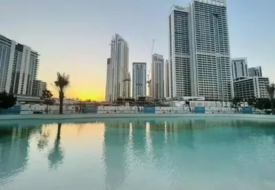 a large pool of water in front of a city at DB HOMs in Dubai