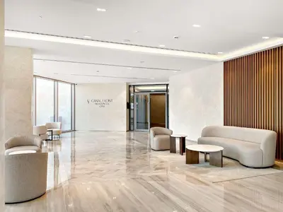 a lobby with chairs and tables in a building at Silkhaus Charming 1BDR in Canal Front Tower in Dubai