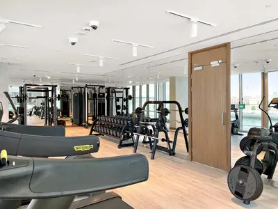 a gym with several treadmills and cardio machines at Silkhaus Charming 1BDR in Canal Front Tower in Dubai