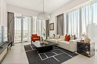 a living room with a couch and a table at Silkhaus Elite 1BDR in Canal Front Tower in Dubai