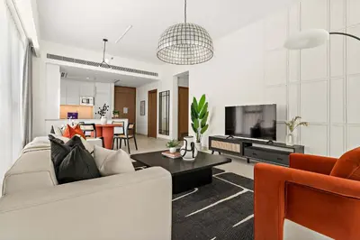 a living room with a couch and a tv at Silkhaus Elite 1BDR in Canal Front Tower in Dubai