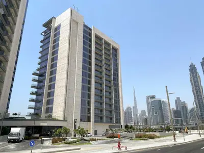 a tall white building in the middle of a city at Silkhaus Luxury 1BDR Stay in Canal Front, Al Wasl in Dubai