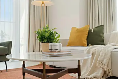 a living room with a table and a couch at Silkhaus Luxury 1BDR Stay in Canal Front, Al Wasl in Dubai