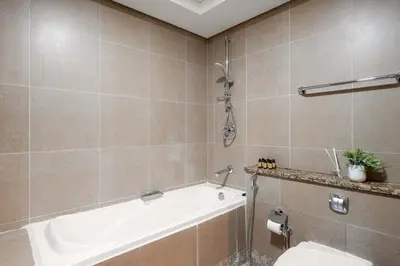 a bathroom with a bath tub and a toilet at Silkhaus Elegant 1BDR in Sky gardens with Metro Access in Dubai