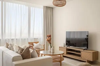 a living room with a couch and a tv at Silkhaus Urban 1BDR Escape in Heart of DIFC in Dubai