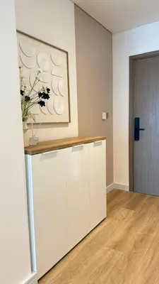 a white room with a vase of flowers on a counter at Luxury 2BR Downtown ,5 min walk to Burj Khalifa and Dubai Mall in Dubai