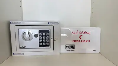 a microwave with a first aid kit and a box at Luxury 2BR Downtown ,5 min walk to Burj Khalifa and Dubai Mall in Dubai