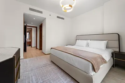 a bedroom with a large bed and a dresser at 3BR Central Park, Prime Dubai Location in Dubai