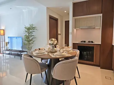 a kitchen and dining room with a table and chairs at Brand New 1BR , Fully Furnished in Dubai