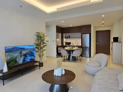 a living room with a couch and a table at Brand New 1BR , Fully Furnished in Dubai