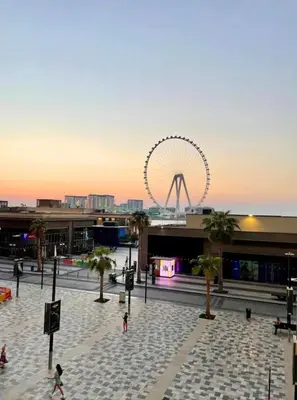 a ferris wheel in the middle of a city at Fav 2-Bedroom by The Beach in JBR Bahar with stunning Marina View in Dubai