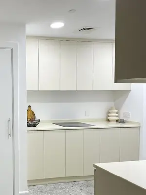 a kitchen with white cabinets and a bowl on the counter at Fav 2-Bedroom by The Beach in JBR Bahar with stunning Marina View in Dubai