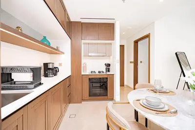 a kitchen and dining room with a table and chairs at Escape24 Luxury 1BR with Sea View and Beach Access, Dubai Harbour in Dubai