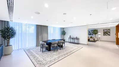 a dining room with a black table and chairs at Escape24 Luxury 1BR with Sea View and Beach Access, Dubai Harbour in Dubai