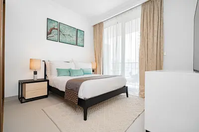 a bedroom with a bed and a large window at Escape24 Luxury 1BR with Sea View and Beach Access, Dubai Harbour in Dubai
