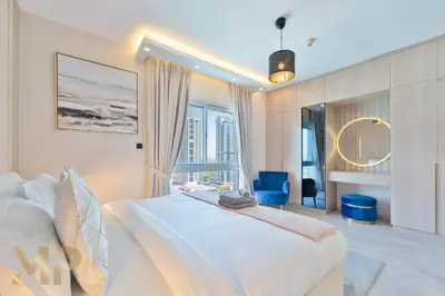 a bedroom with a large bed and a large window at Marcopolo -Enjoy Marina views from a cozy 1BR in Dubai Marina in Dubai