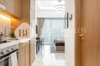 a view of a kitchen and dining room from the hallway at Bloomfields Deluxe Studio In Azizi Riviera in Dubai