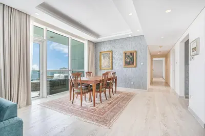 a dining room with a table and chairs at JBR Home with incredible View & Private Beach in Dubai
