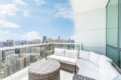 a balcony with a couch and a view of the city at JBR Home with incredible View & Private Beach in Dubai