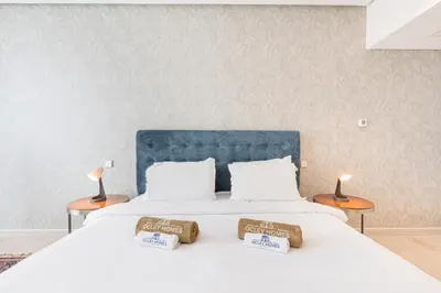 a bedroom with a large white bed with two lamps at JBR Home with incredible View & Private Beach in Dubai