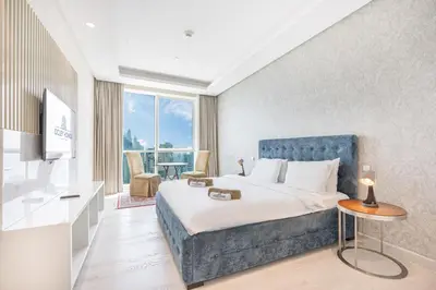 a hotel room with a bed and a television at JBR Home with incredible View & Private Beach in Dubai