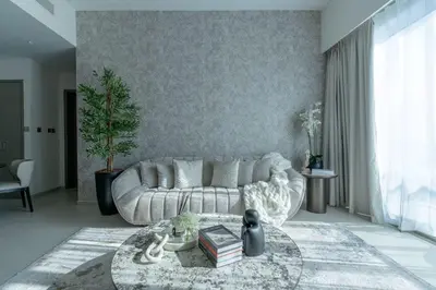 a living room with a white couch and a table at Nasma Luxury Stays - Chic HighRise 1 BR in the Heart of Dubai in Dubai
