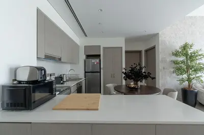 a kitchen with a white counter top with a microwave at Nasma Luxury Stays - Chic HighRise 1 BR in the Heart of Dubai in Dubai