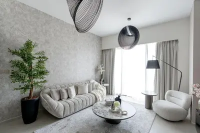 a living room with a couch and a table at Nasma Luxury Stays - Chic HighRise 1 BR in the Heart of Dubai in Dubai