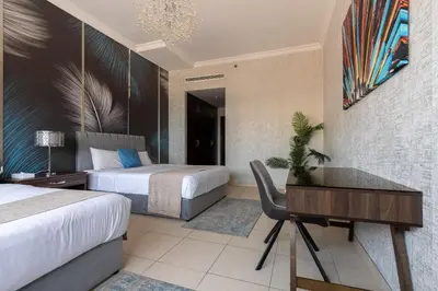 a hotel room with two beds and a desk at Luxury Beachfront Villa with Private Pool on Palm Jumeirah near Atlantis in Dubai
