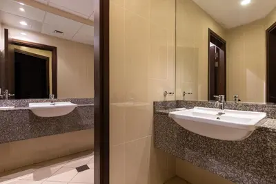 a bathroom with two sinks and a mirror at Luxury Beachfront Villa with Private Pool on Palm Jumeirah near Atlantis in Dubai