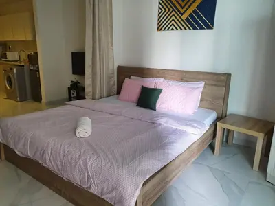 a bedroom with a bed with pink sheets and pillows at Millennium Binghatti Residence - Business Bay - Homeyvillas in Dubai