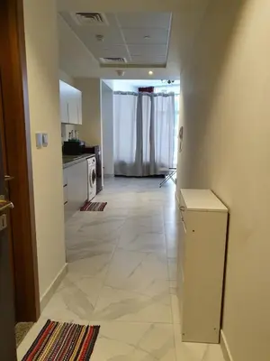 an empty hallway of a kitchen with a refrigerator at Millennium Binghatti Residence - Business Bay - Homeyvillas in Dubai