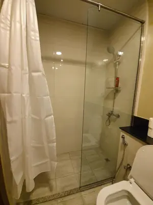 a bathroom with a shower and a toilet at Millennium Binghatti Residence - Business Bay - Homeyvillas in Dubai