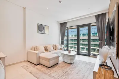 a living room with a couch and a large window at Seven Palm Residence with stunning view in Dubai