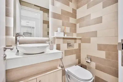a bathroom with a sink and a toilet at Seven Palm Residence with stunning view in Dubai