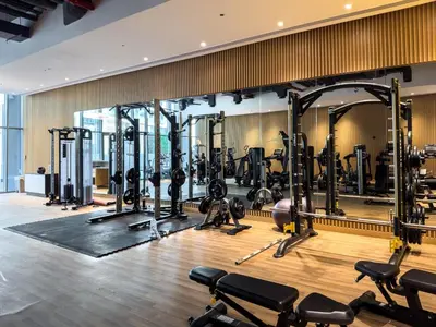 a gym with a large mirror and lots of machines at Seven Palm Residence with stunning view in Dubai