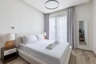 a white bedroom with a bed with towels on it at Ahad Residences Skyline Studio in Business Bay in Dubai