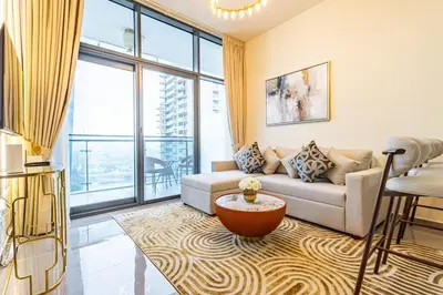 a living room with a couch and a large window at Lovely 1BR Business Bay near Metro - City Skyline Views in Dubai