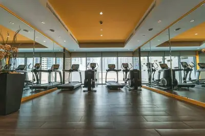 a gym with treadmills and ellipticals in a building at Lovely 1BR Business Bay near Metro - City Skyline Views in Dubai