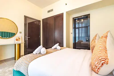 a bedroom with a large white bed with a mirror at Lovely 1BR Business Bay near Metro - City Skyline Views in Dubai